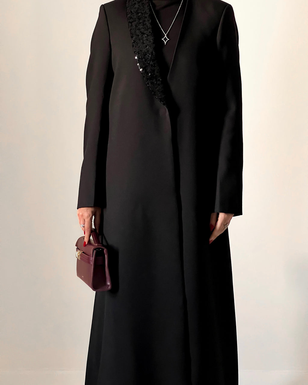 Blazer cut abaya crafted from premium crepe, finished with a sequin detailed on one side collar.