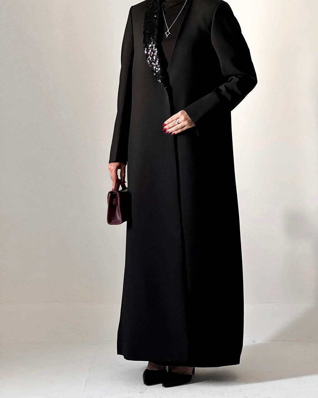 Blazer cut abaya crafted from premium crepe, finished with a sequin detailed on one side collar.