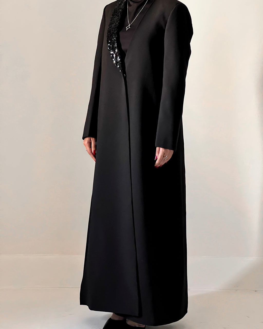 Blazer cut abaya crafted from premium crepe, finished with a sequin detailed on one side collar.