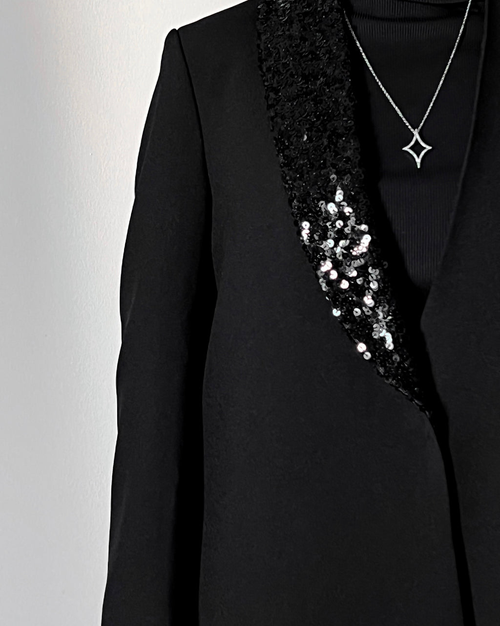 Blazer cut abaya crafted from premium crepe, finished with a sequin detailed on one side collar.