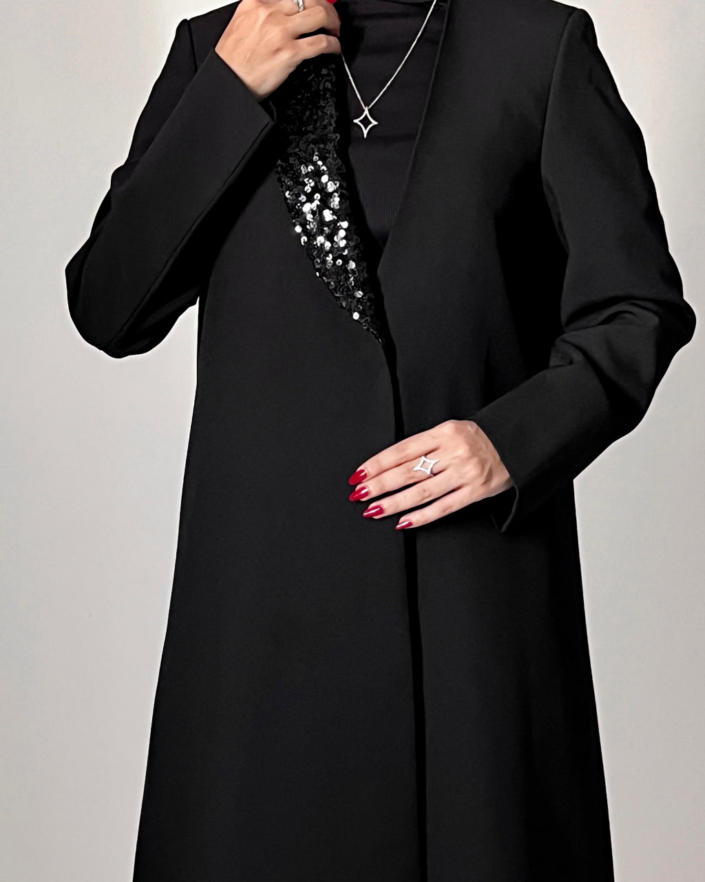 Blazer cut abaya crafted from premium crepe, finished with a sequin detailed on one side collar.