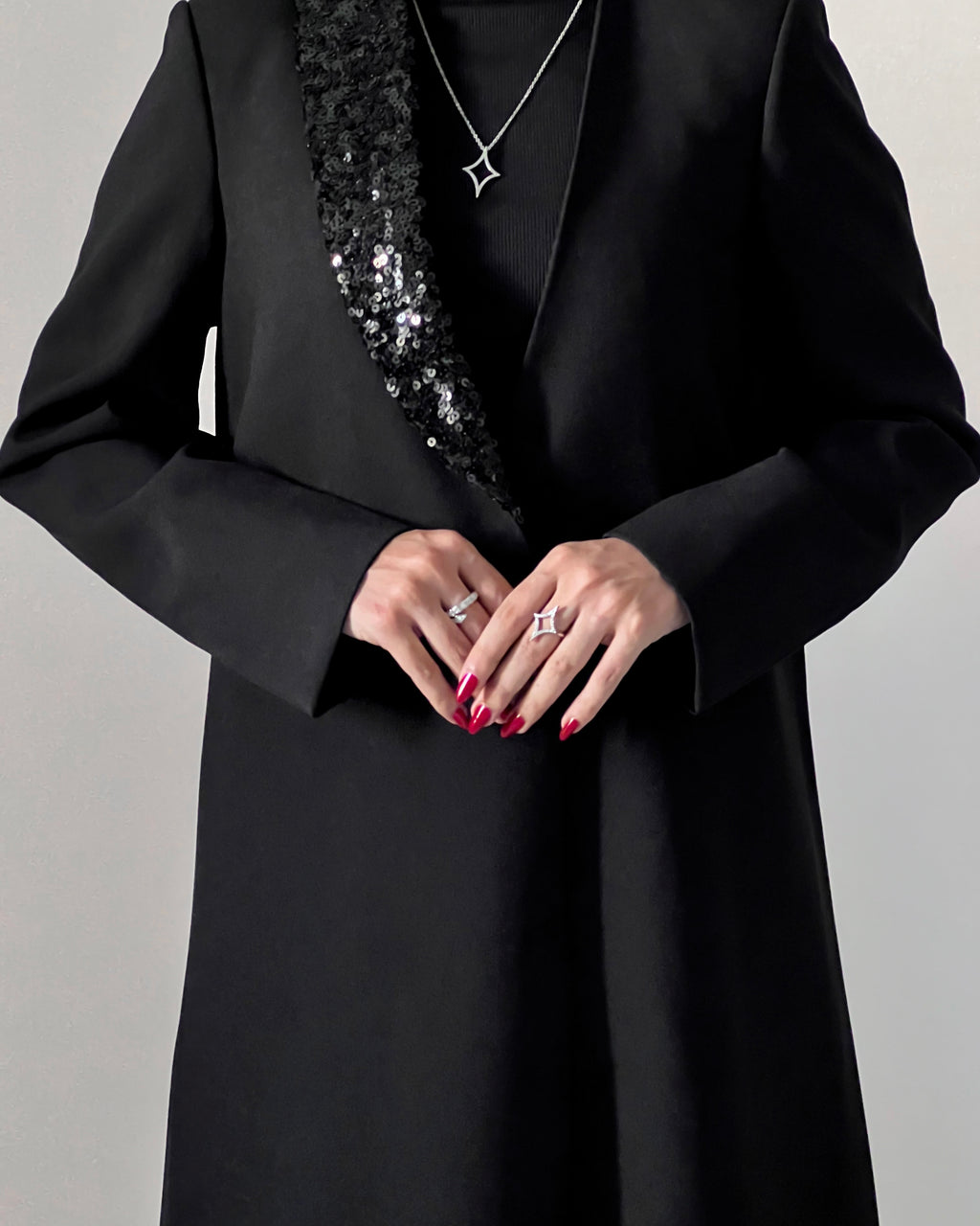 Blazer cut abaya crafted from premium crepe, finished with a sequin detailed on one side collar.
